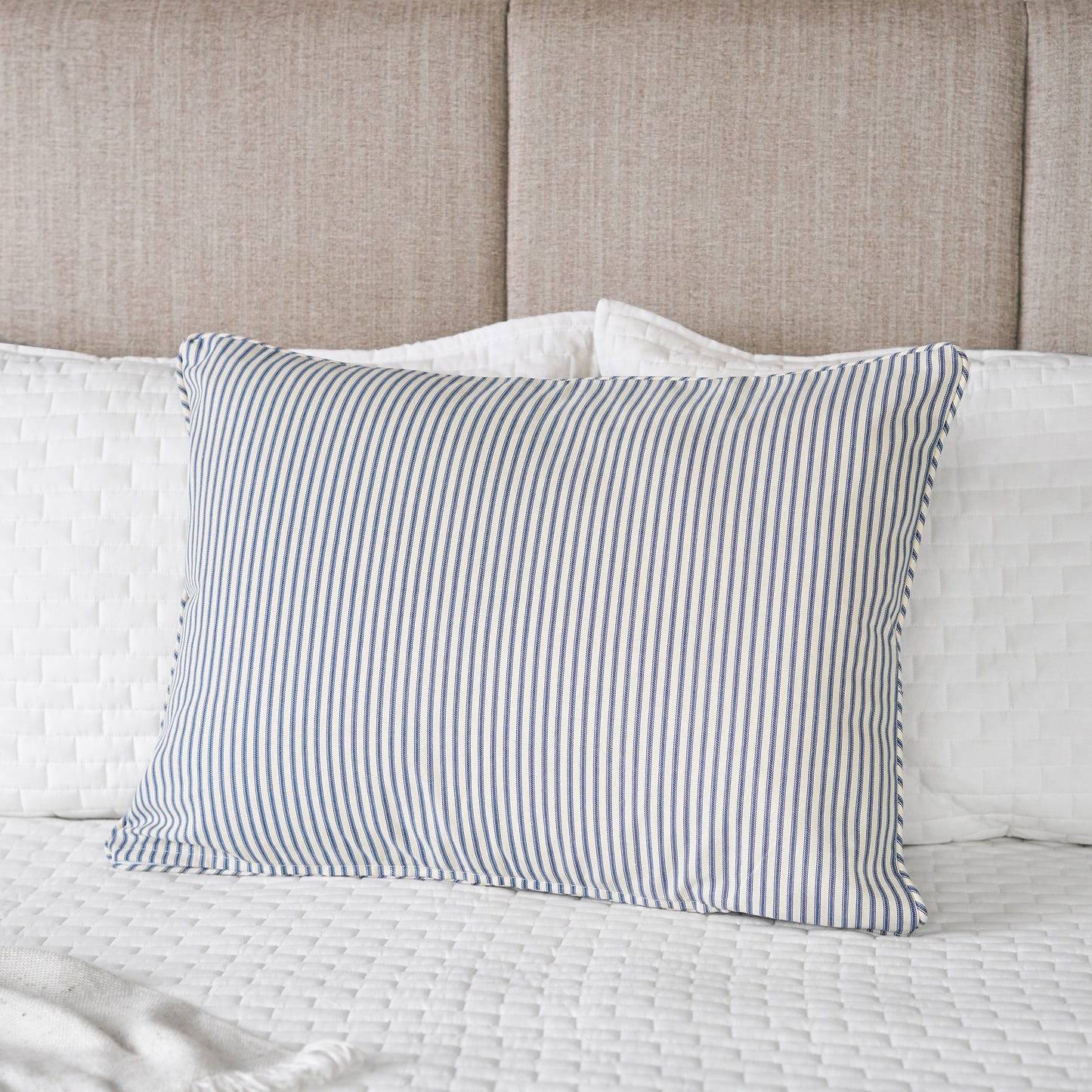 blue and cream stripe sham on bed