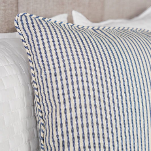 blue ticking stripe pillow sham detail on bed