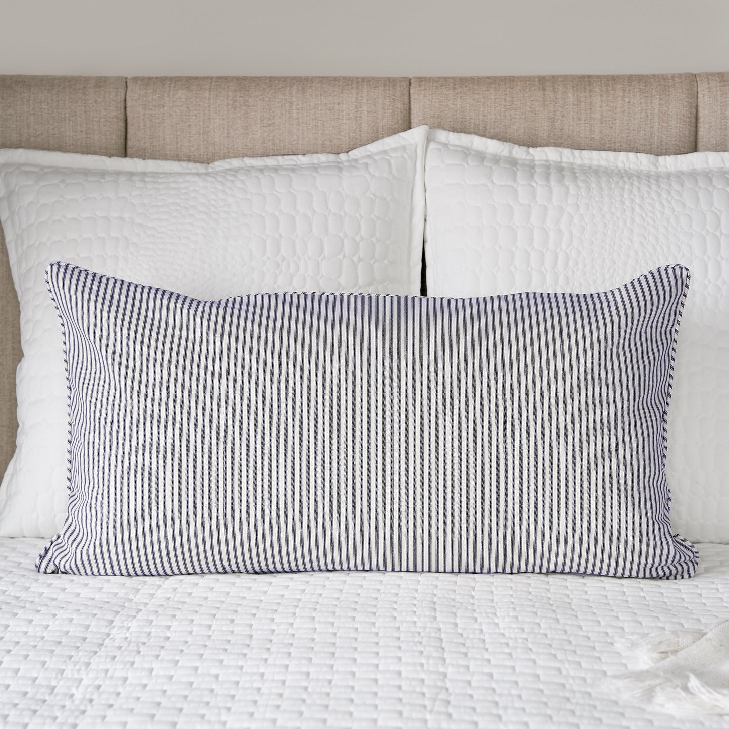 blue and cream ticking stripe pillow sham on bed