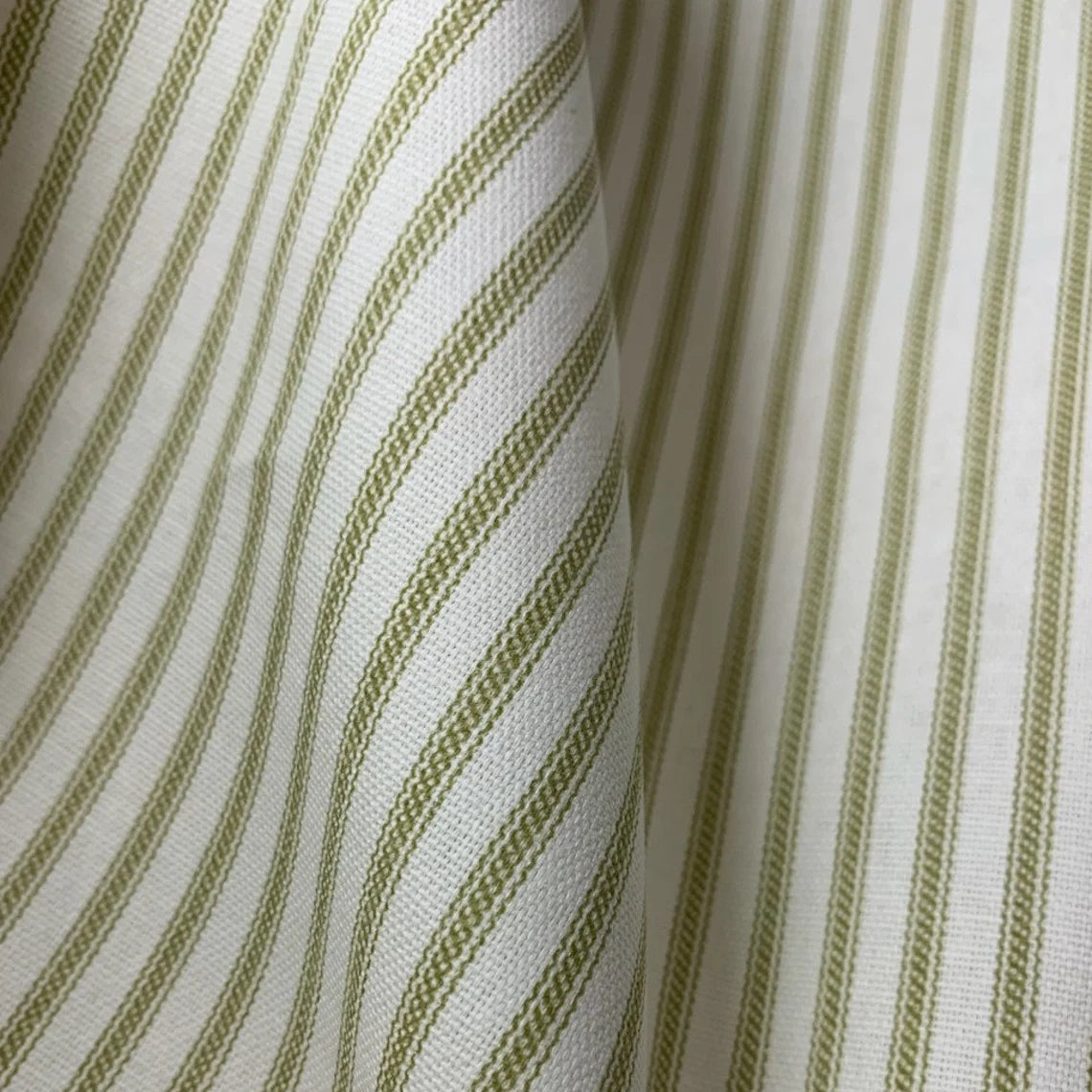 close up of olive green and cream ticking stripe fabric for bedding and duvet covers