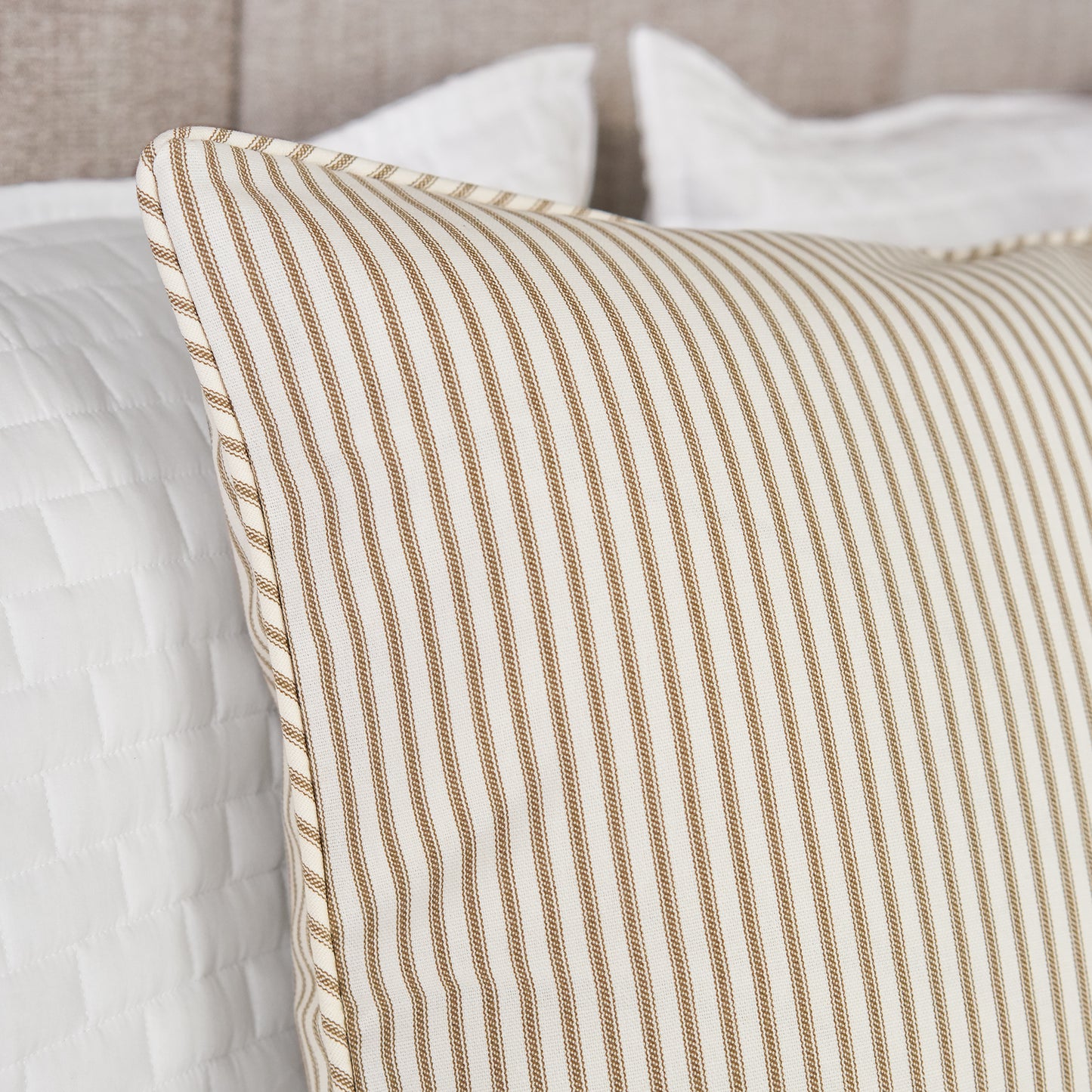 detail of brown ticking stripe standard sham on bed closeup