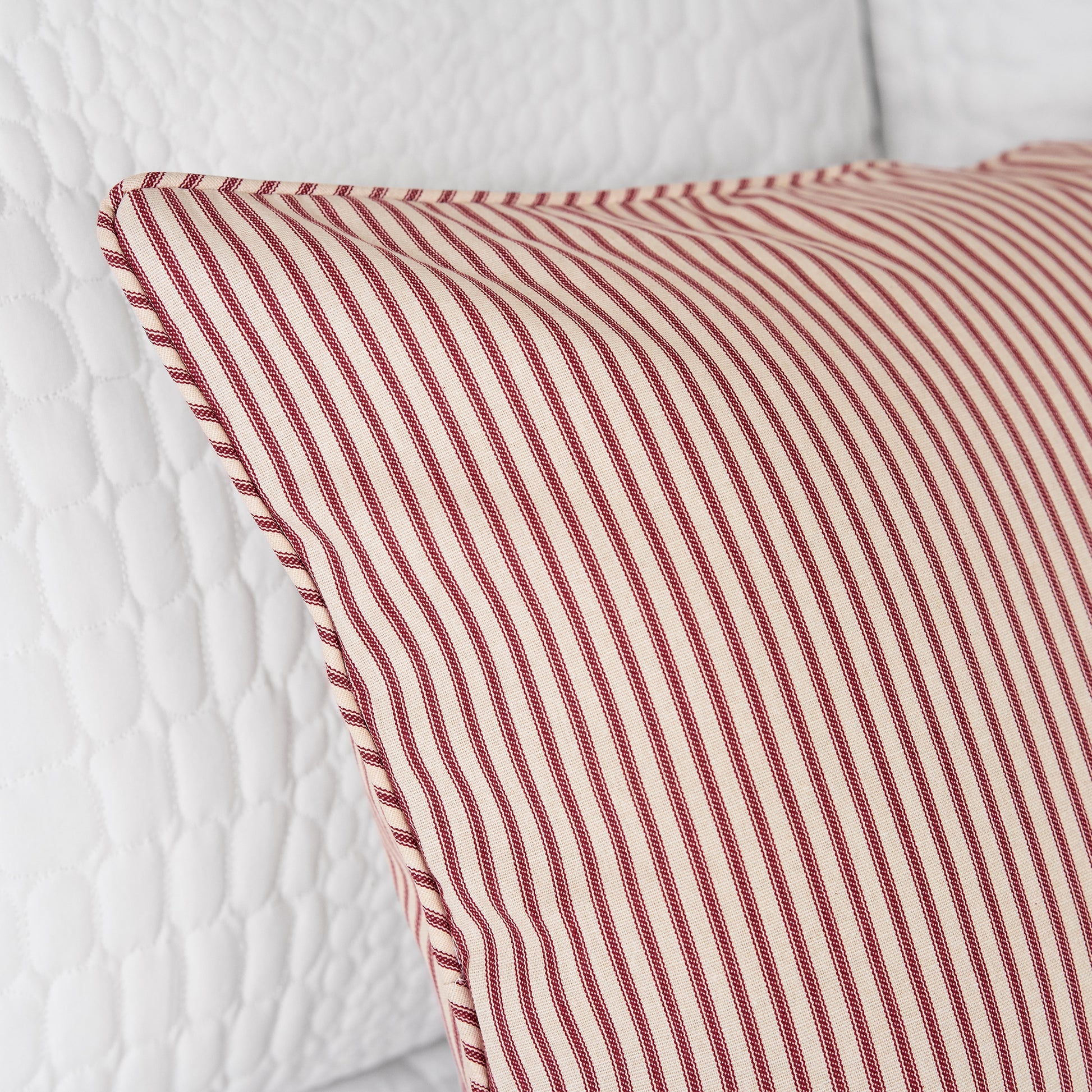 detail of king pillow sham in red and ivory stripe