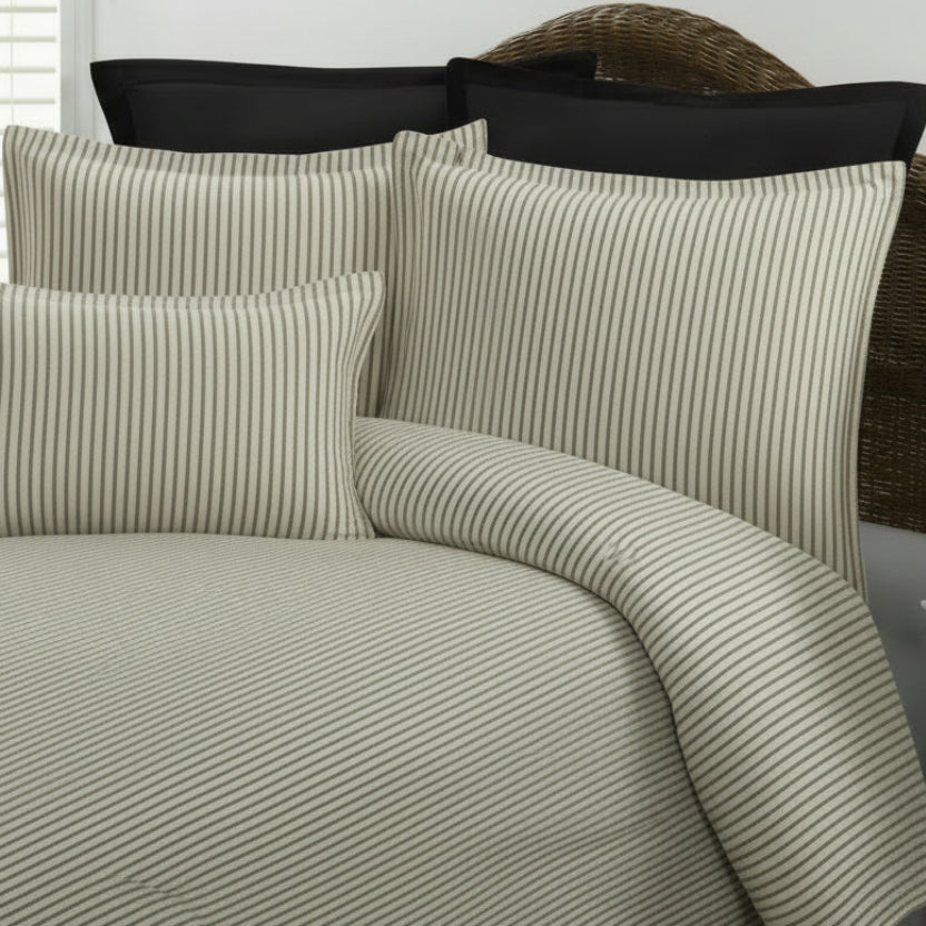 gray and cream striped bedding on a bed 