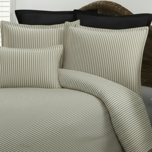 gray and cream striped bedding on a bed 