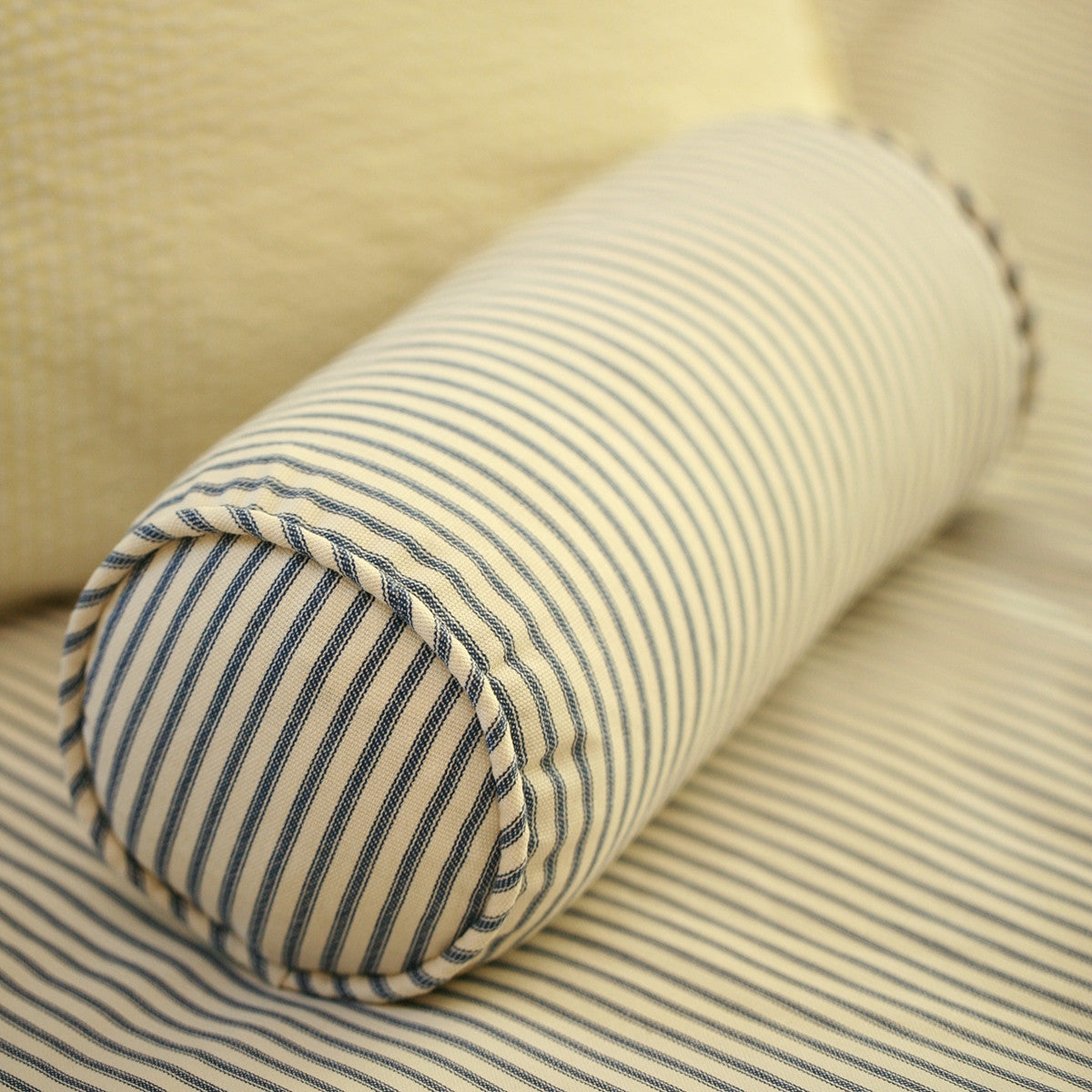 Navy Blue Ticking Stripe Bolster Neckroll Pillow  on Blue striped bed