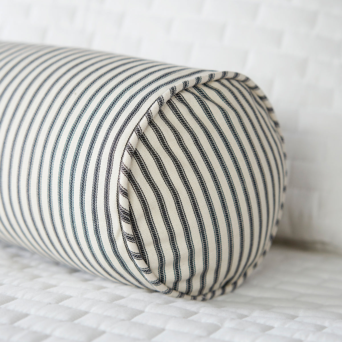 Black Ticking Stripe Bolster Pillow on White Bed