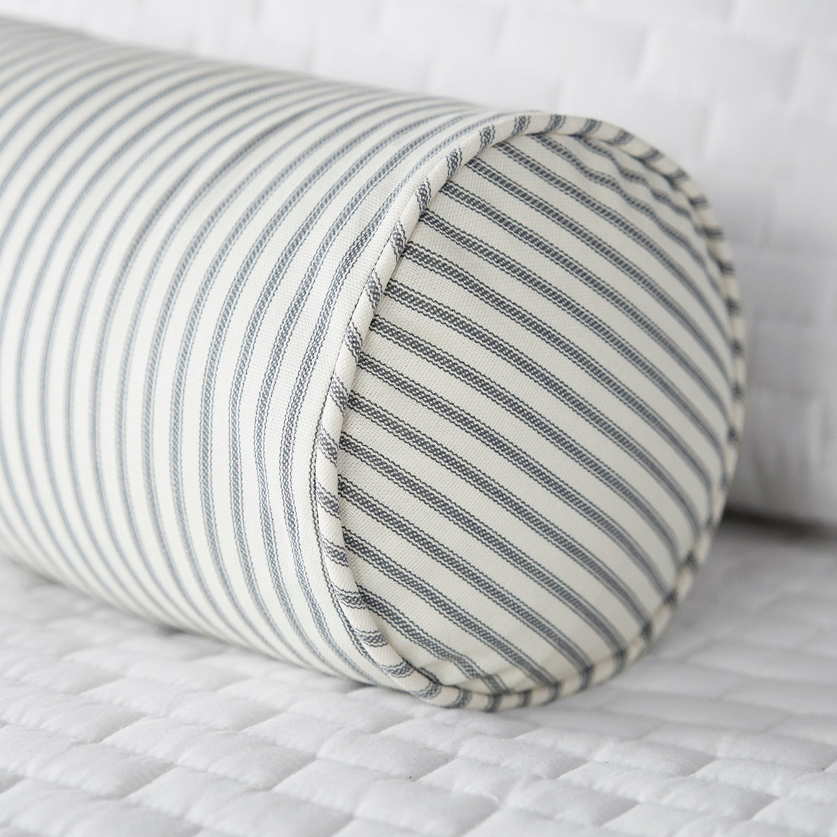 Gray Ticking Stripe Bolster Pillow on White Bed